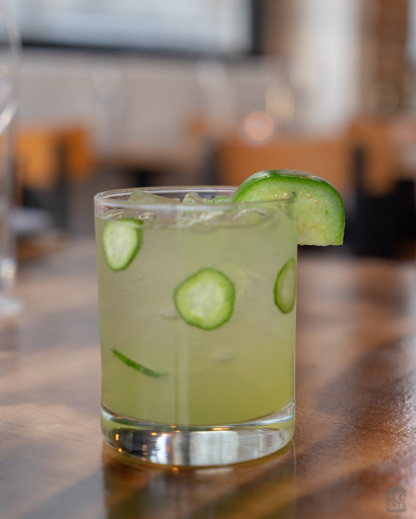 A photo of a green cocktail with jalapeño and tomatillo